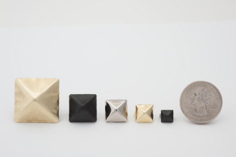 May include: Assortment of pyramid-shaped metal studs in gold, silver, and black. The studs are arranged in order of size, with the largest stud on the left and the smallest stud on the right. A US quarter is included for scale.