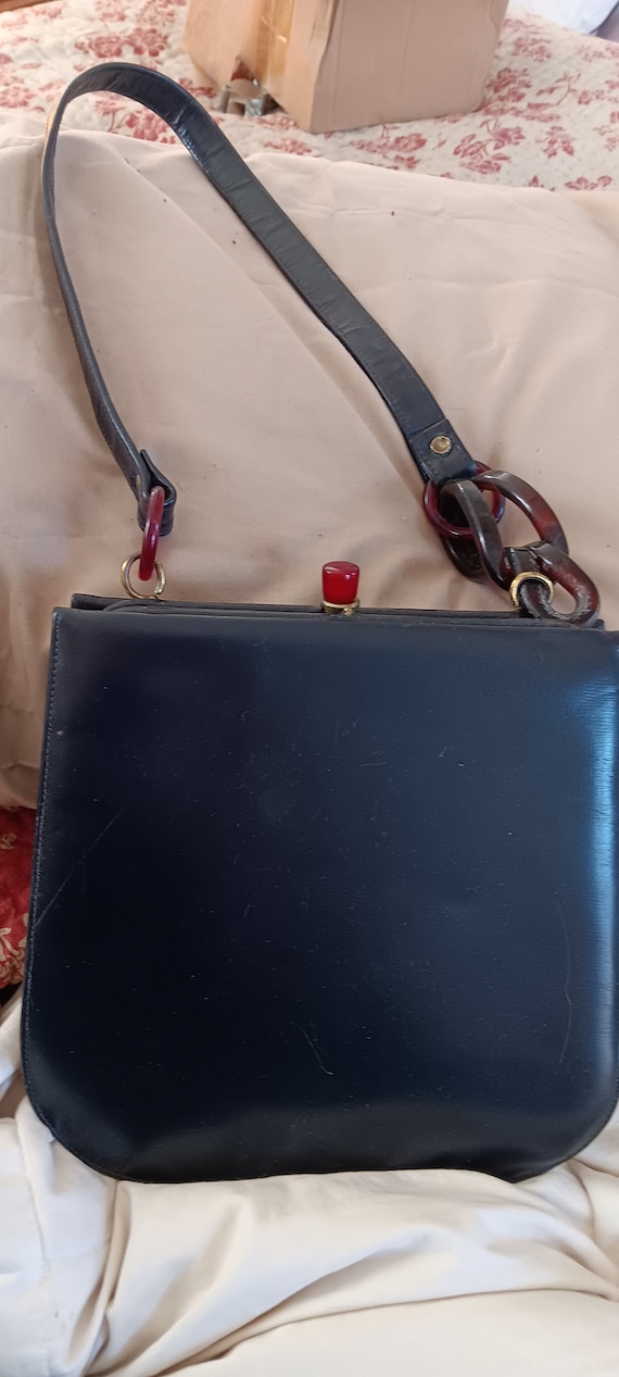 vintage black purse with very interesting strap. B
