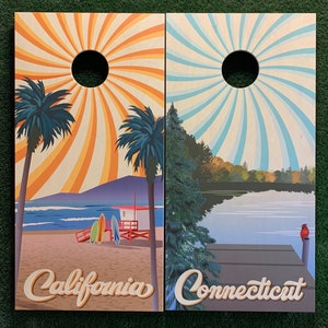 May include: Two wooden cornhole boards with a beach scene on one and a lake scene on the other. The beach scene has palm trees, a lifeguard stand, and the text "California". The lake scene has a dock, a red cardinal, and the text "Connecticut".