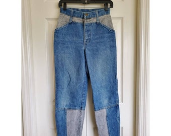 May include: High-waisted blue denim jeans with gray denim panels on the waistband, pockets, and lower legs.