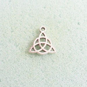 May include: Silver charm in the shape of a Celtic knot, a triangular design with interlacing loops.