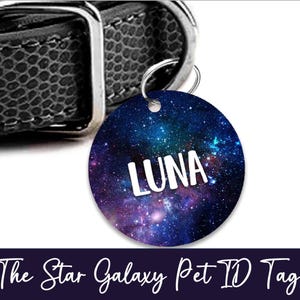 May include: A round pet ID tag with a galaxy design, featuring the name "LUNA" in white. The tag is attached to a black leather collar. The text "The Star Galaxy Pet ID Tag" is at the bottom.