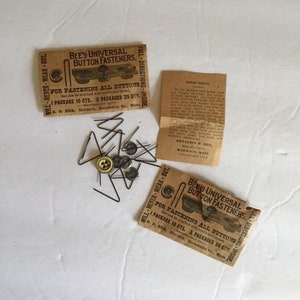 May include: Two vintage packages of Bee's Universal Button Fasteners. The packages are brown with black text and illustrations of a button fastener. The text on the packages reads "Bee's Universal Button Fasteners. For fastening all buttons that can be attached with needles and thread. 1 Package 10 cts. 3 Packages 25 cts. B. F. Bee, Harwich, Barnstable Co., Mass."