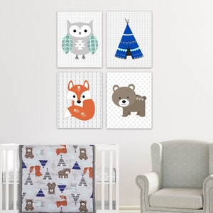 May include: A nursery decor set with a gray, white, and blue color scheme. The set includes four prints featuring an owl, a teepee, a fox, and a bear. The prints are surrounded by a gray crib with a matching gray and blue quilt featuring the same animal and teepee designs.