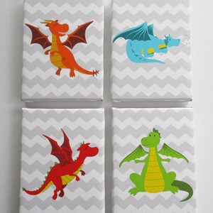 May include: Four square canvas art prints featuring colorful cartoon dragons. Each dragon is a different color: orange, blue, red, and green. The background is a gray and white chevron pattern.