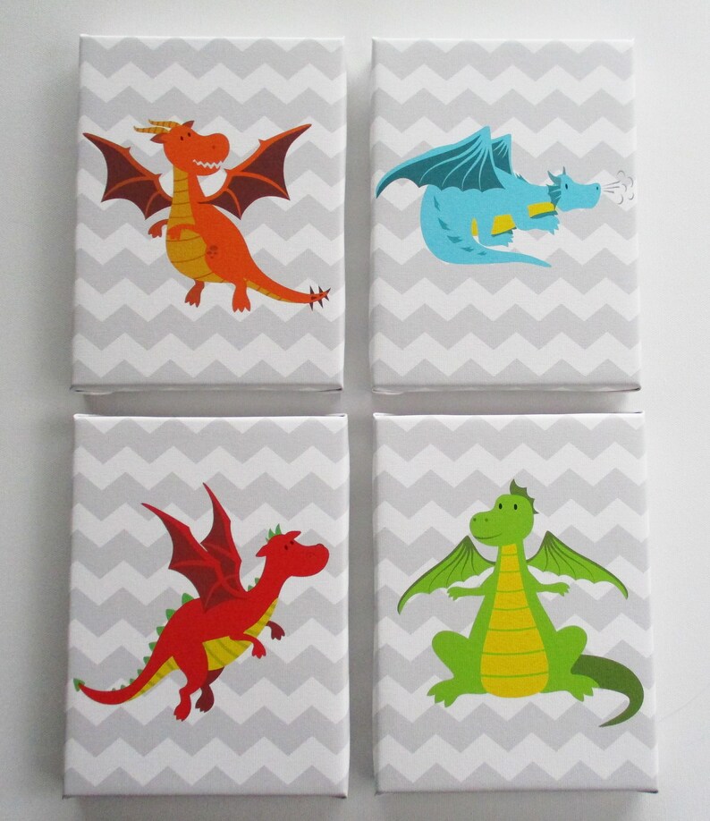 May include: Four square canvas art prints featuring colorful cartoon dragons. Each dragon is a different color: orange, blue, red, and green. The background is a gray and white chevron pattern.