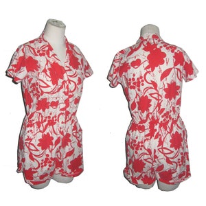 May include: A white and red floral print short jumpsuit with a collared neckline and short sleeves.
