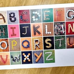 May include: A colourful alphabet poster with each letter made from different materials, such as buttons, beads, and straws.