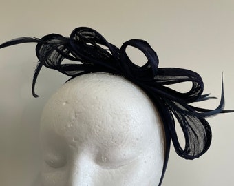 Navy silk abaca loop fascinator with feathers on a headband.