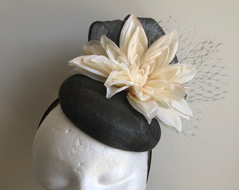 New grey fascinator with silk abaca loops, flowers and netting on a black headband