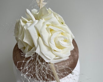 Brown fascinator with cream flowers and feathers!