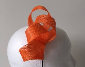 Orange loop fascinator on a metal headband. Stunning on!