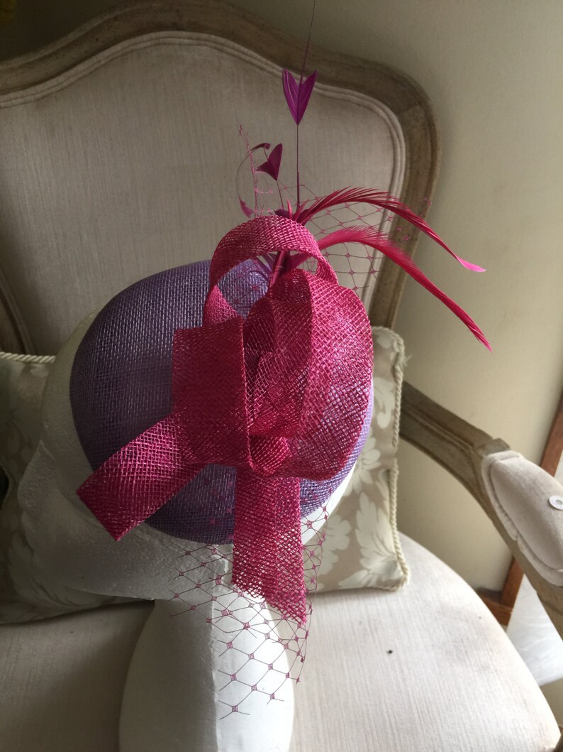 Stunning! feathers and netting Gorgeous lilacpurple round fascinator with magenta loops