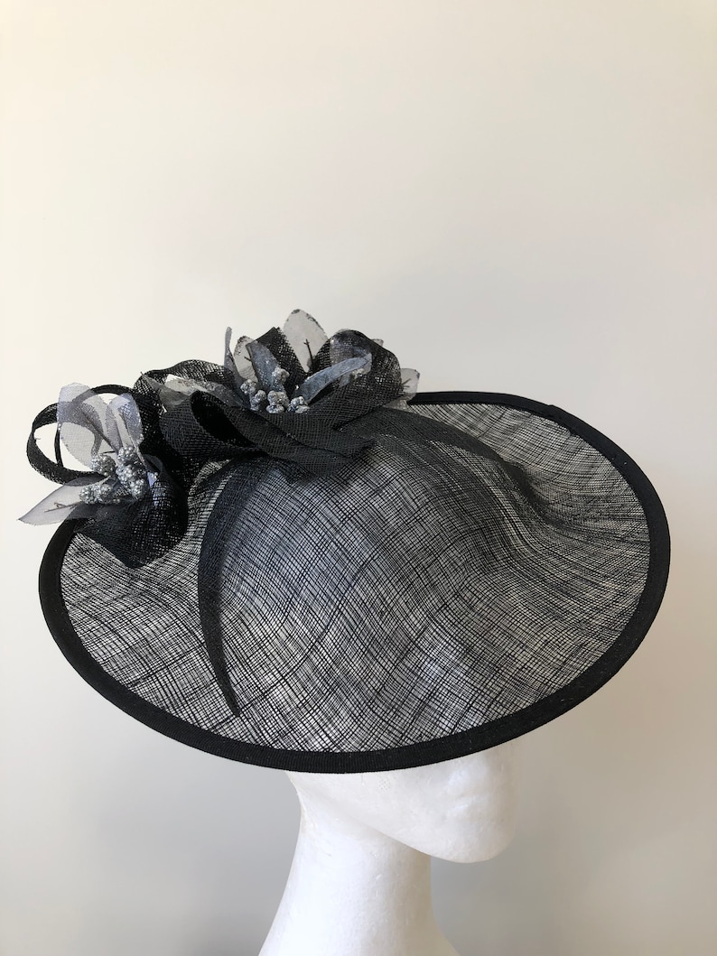 New black saucer fascinator with silver flowers and black loops on a headband!