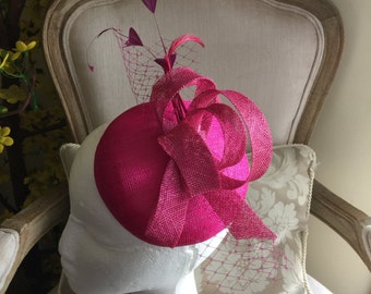 Gorgeous pink coloured round fascinator with magenta loops, feathers and netting. Made to order!