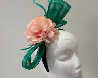 Magenta silk abaca fascinator with orchids and feathers on a headband.