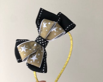 New kids gold and black bow headband on a gold band. Stunning on!