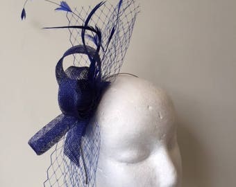 New blue loop, netting and feathered fascinator on a headband. Stunning on!