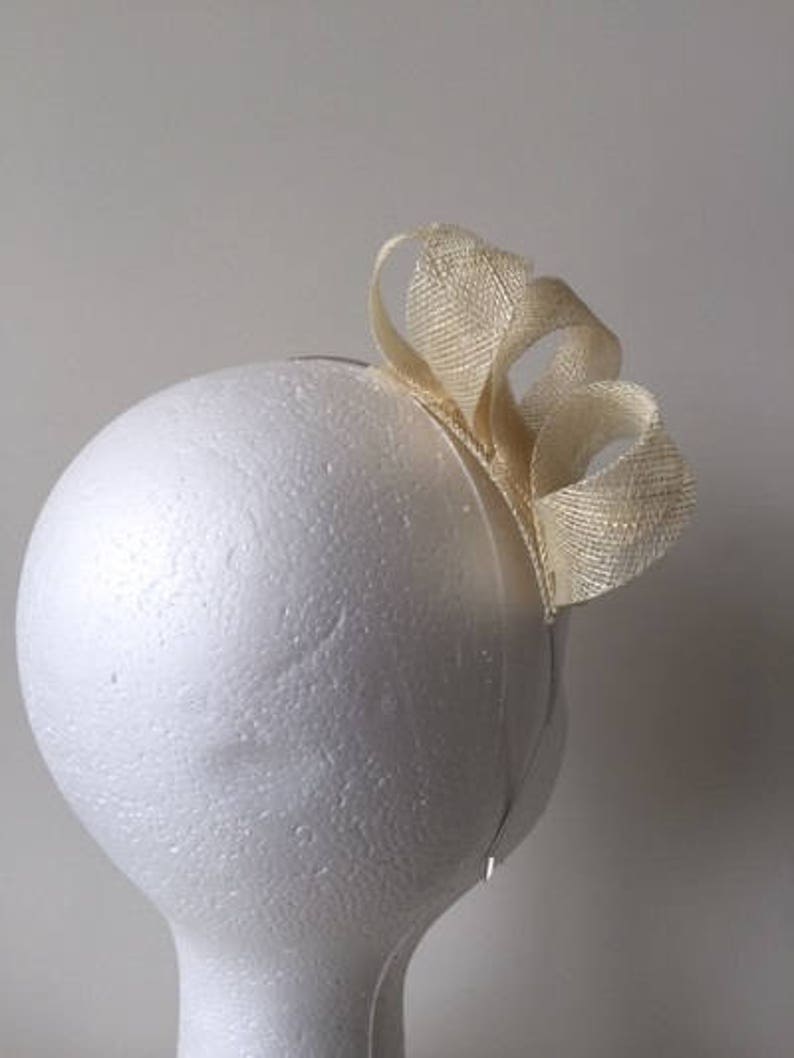 Stunning on! Cream loop fascinator on a metal headband