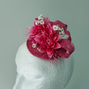 Pink Sinamay Fascinator with loops, pink and white flowers.
