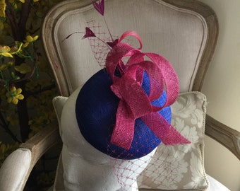 Gorgeous royal blue round fascinator with magenta loops, feathers and netting. Stunning!