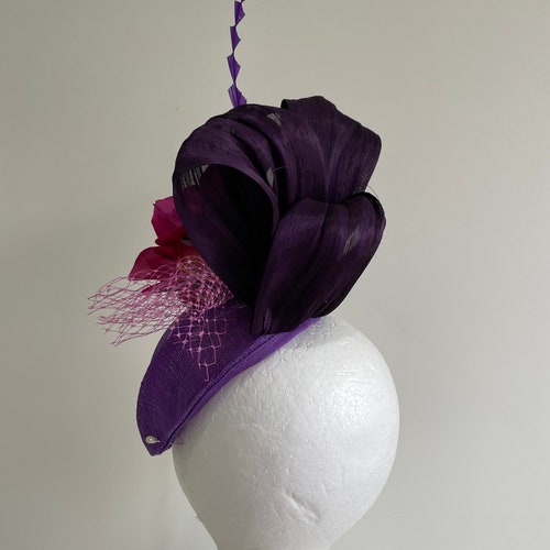 Purple air hostess fascinator with loops, magenta flowers and orders feathers!