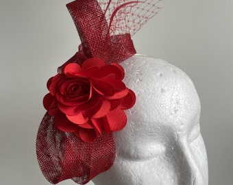 Red fascinator with loops, feathers and a flower on a headband!