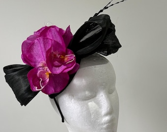 Black silk abaca fascinator with magenta orchids and black feathers on a headband.
