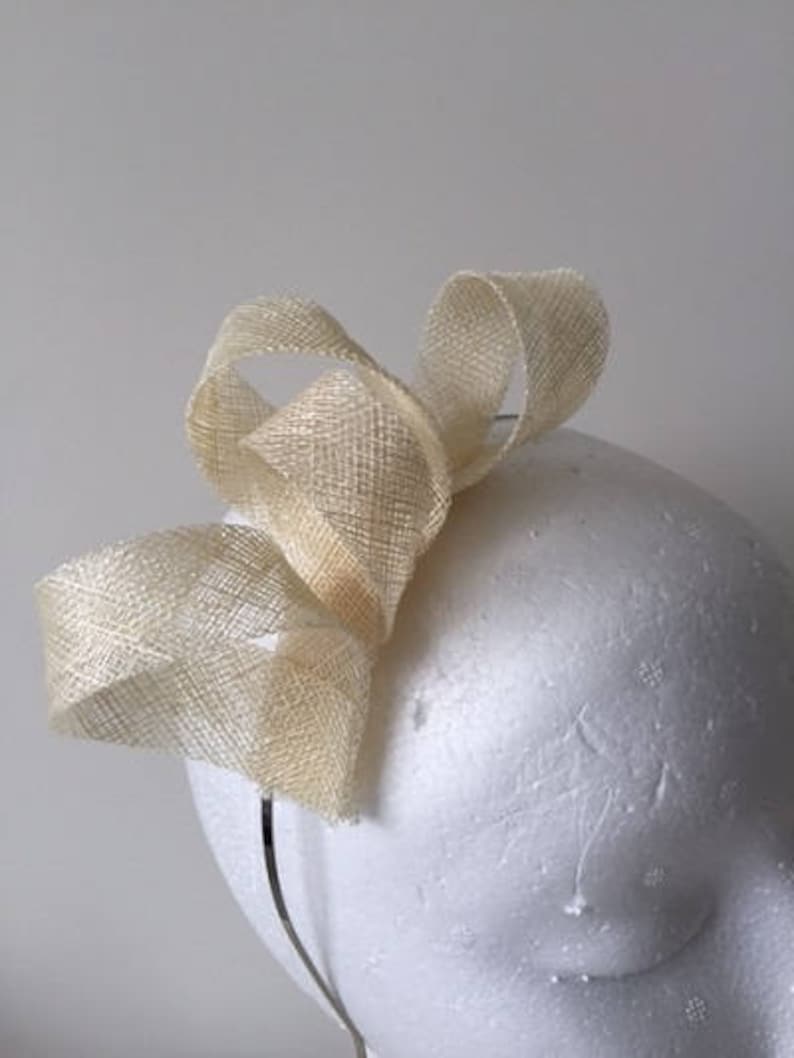 Stunning on! Cream loop fascinator on a metal headband