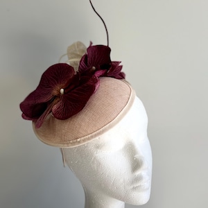 Cream saucer base sinamay fascinator with cream loops and red flowers and quill