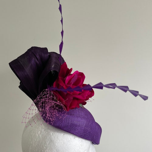 Purple air hostess fascinator with loops, magenta flowers and orders feathers!