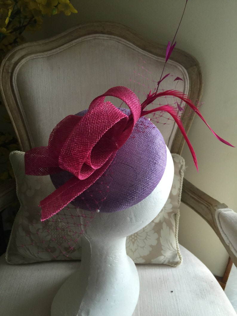 Stunning! feathers and netting Gorgeous lilacpurple round fascinator with magenta loops