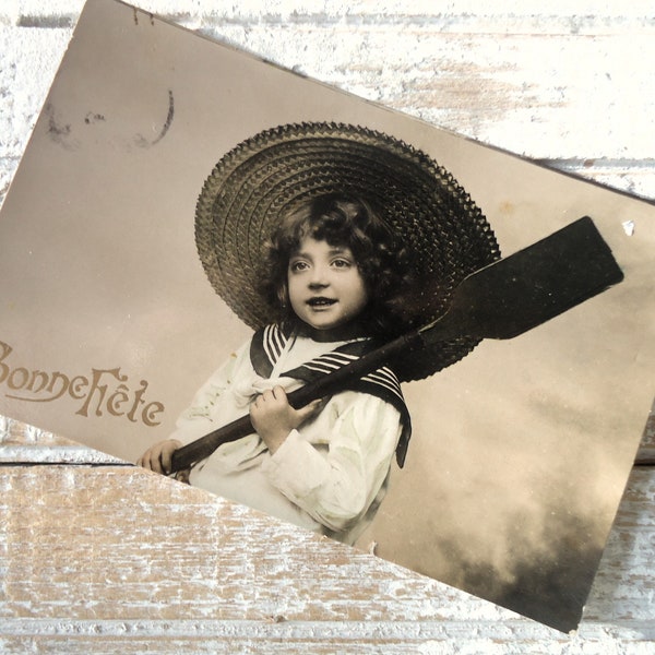 Antique french postcard - Little boy child, Edwardian sailor suit, portrait straw hat, oar ready to row, hand tinted, 1900