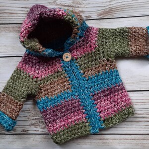 Hand made crochet layette in multicoloured, acrylic yarn. Outfit is a jacket, boots and hat set.  Perfect baby shower gift. Boho. Batik.