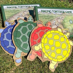 May include: A board game called "Racing Tortoise Game" with four colorful tortoise pieces. The game box has the text "If you can pull a string, you can play."