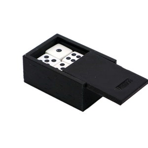 May include: A black box with a hinged lid, containing four white dice with black dots. The box is made of a textured material and has a small, rectangular label on the lid.