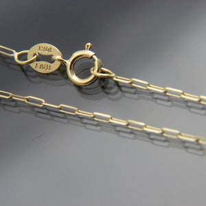 May include: A gold chain necklace with a lobster clasp and a tag that reads "ITAL 10KT".