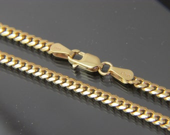 May include: A gold curb chain necklace with a lobster clasp. The chain is made of 14k gold and is 20 inches (50.8 cm) long.