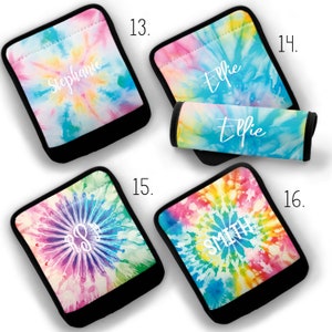 May include: Four tie-dye fabric covered pot holders with black trim. The pot holders feature the names "Stephanie", "Ellie", "R&R", and "Smith" in white lettering.
