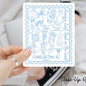 May include: A blue and white illustrated sticker with the text "Macey's Last Toast on the Coast" and "Charleston, SC 2025". The sticker features various beach-themed illustrations, including a seashell, a palm tree, a surfboard, a horseshoe, a starfish, a seahorse, and a cowboy hat.