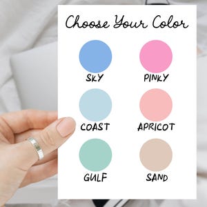 May include: A white card with the text "Choose Your Color" and six color swatches labeled "Sky", "Pinky", "Coast", "Apricot", "Gulf", and "Sand".