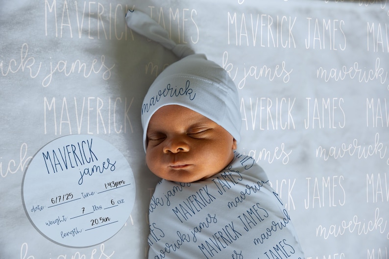 May include: A newborn baby wrapped in a swaddle blanket and wearing a matching hat, both with the name "Maverick James" printed on them. A circular sign displays the baby's birth details: date, time, weight (7 lbs, 6 oz), and length (20.5 inches).