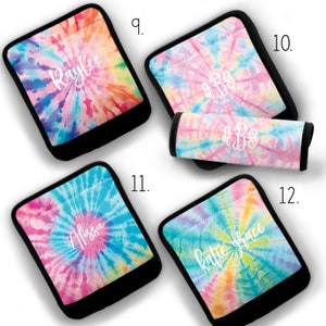 May include: Four tie-dye fabric covers with black trim. The covers are for car seat handles. The covers feature different names and monograms. The covers are in a rainbow tie-dye pattern.