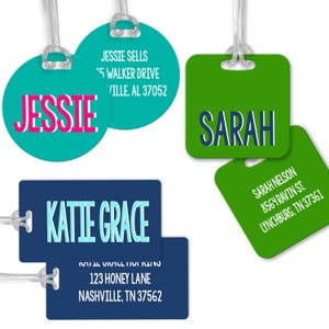 May include: Four luggage tags with different names and addresses. The tags are made of plastic and have a clear plastic strap. The tags are in various colors, including green, blue, and turquoise.