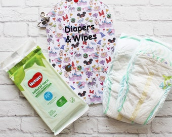May include: A diaper and wipes set featuring a patterned pouch with Disney characters and the text "Diapers & Wipes." Includes a package of Huggies natural care wipes and two diapers. The set is designed for baby care.