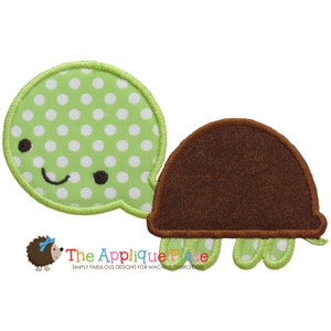 May include: Green and brown applique of a turtle with white polka dots. The turtle has a smiling face and a brown shell.