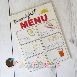 Puede incluir: Un menú de desayuno blanco bordado con un sol amarillo, texto rojo que dice "Breakfast Menu" e imágenes de huevos, tostadas, tocino, panqueques y jugo.