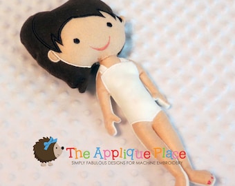 May include: A handmade doll with brown hair, a white sleeveless dress, and pink nail polish. The doll is lying on a white textured surface.