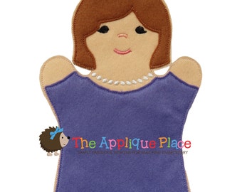May include: A felt puppet of a woman with brown hair, wearing a purple dress and a pearl necklace. The puppet is designed for finger play and storytelling.