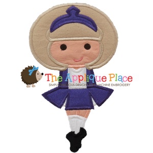 May include: An embroidered design of a cartoon character in a purple and white uniform with a tan helmet. A small hedgehog with a blue bow is to the left. The text "The Applique Place" is below the character.